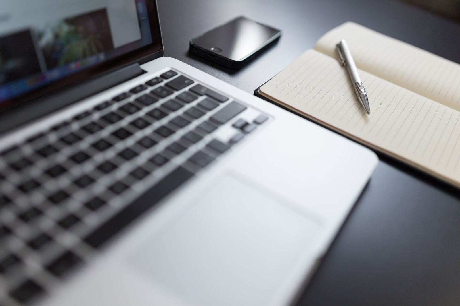 Modern workspace with a laptop and notebook