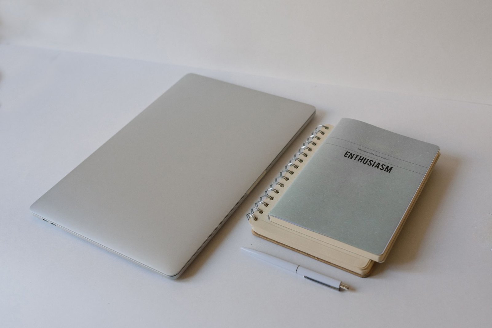 Closed laptop and notepad on a desk