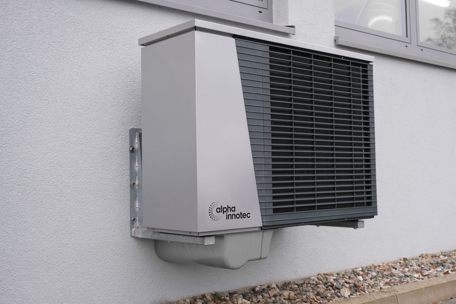 Outdoor heat pump unit mounted on a residential building