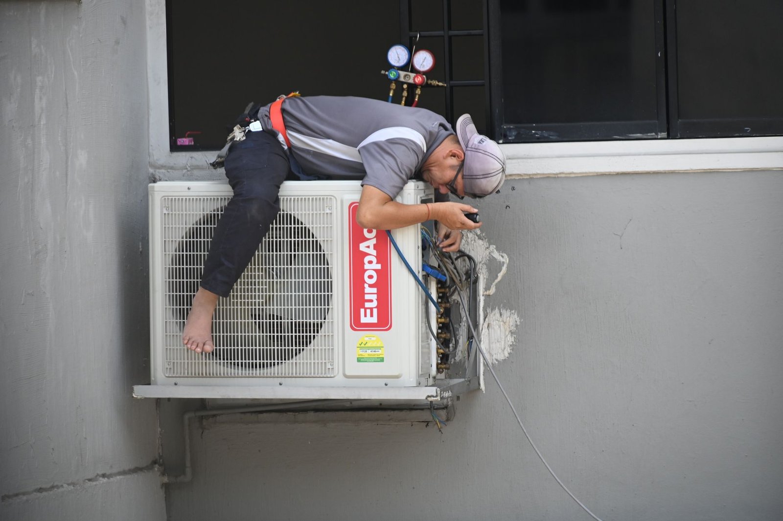 HVAC technician repairing an outdoor ductless unit